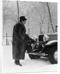 1930s Man In Hat And Raccoon Fur Coat Standing Foot On Bumper Of Chevrolet Roadster Stalled In Snow Storm by Anonymous