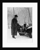 1930s Man In Hat And Raccoon Fur Coat Standing Foot On Bumper Of Chevrolet Roadster Stalled In Snow Storm by Anonymous