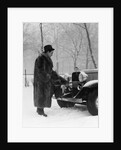 1930s Man In Hat And Raccoon Fur Coat Standing Foot On Bumper Of Chevrolet Roadster Stalled In Snow Storm by Anonymous