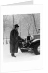1930s Man In Hat And Raccoon Fur Coat Standing Foot On Bumper Of Chevrolet Roadster Stalled In Snow Storm by Anonymous