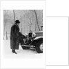 1930s Man In Hat And Raccoon Fur Coat Standing Foot On Bumper Of Chevrolet Roadster Stalled In Snow Storm by Anonymous