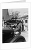 1930s Service Station Attendant In Cap and Coveralls Pouring Water From Spouted Can Into Automobile Radiator by Anonymous