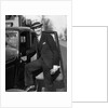 1930s Man In Suit And Hat Holding Gloves Stepping Into Automobile Driver Seat by Anonymous