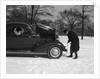 Woman Passenger Watching Man Motorist Try To Crank Start A Chevrolet Coupe Stalled In Snow by Anonymous