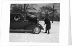 Woman Passenger Watching Man Motorist Try To Crank Start A Chevrolet Coupe Stalled In Snow by Anonymous