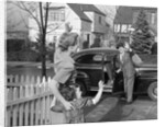1950s Mother And Daughter Waving To Father Opening Automobile Door In Front Of Suburban Home by Anonymous