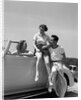 1930s Friends Sitting With Convertible Roadster Automobile Talking Together At Seashore by Anonymous