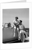 1930s Friends Sitting With Convertible Roadster Automobile Talking Together At Seashore by Anonymous