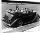 1940s Family Of Four In Convertible Ford V-8 Sedan At Camera by Anonymous