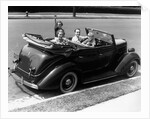 1940s Family Of Four In Convertible Ford V-8 Sedan At Camera by Anonymous