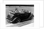 1940s Family Of Four In Convertible Ford V-8 Sedan At Camera by Anonymous