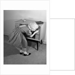 1960s Little Girl Turning On Television Set by Anonymous