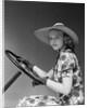 1930s 1940s Woman Wearing Straw Hat Sun Dress Driving Gloves Holding Auto Mobile Steering Wheel Looking At Camera by Anonymous