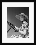 1930s 1940s Woman Wearing Straw Hat Sun Dress Driving Gloves Holding Auto Mobile Steering Wheel Looking At Camera by Anonymous
