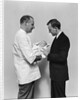 1930s 1940s Man Doctor Showing New Born Infant Baby To Proud Father by Anonymous