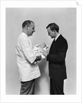 1930s 1940s Man Doctor Showing New Born Infant Baby To Proud Father by Anonymous