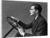 1930s 1940s Man Wearing Suit And Tie Holding Automobile Steering Wheel by Anonymous