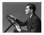 1930s 1940s Man Wearing Suit And Tie Holding Automobile Steering Wheel by Anonymous