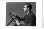 1930s 1940s Man Wearing Suit And Tie Holding Automobile Steering Wheel by Anonymous