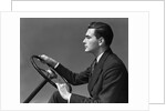 1930s 1940s Man Wearing Suit And Tie Holding Automobile Steering Wheel by Anonymous