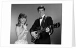 1960s Teenage Entertainment Duo Man Playing Guitar And Woman Singing Holding Microphone by Anonymous