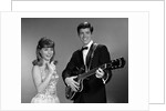 1960s Teenage Entertainment Duo Man Playing Guitar And Woman Singing Holding Microphone by Anonymous