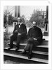 1890s 1900 Two Bearded Men In Suits Holding Bowler Hats Sitting On Stairs In Front Of House by Anonymous