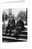 1890s 1900 Two Bearded Men In Suits Holding Bowler Hats Sitting On Stairs In Front Of House by Anonymous