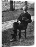 1890s 1900s Side View Of Man Wearing Suit Seated On Chair Outside Holding Bowler Hat by Anonymous