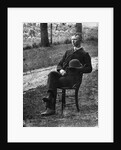 1890s 1900s Side View Of Man Wearing Suit Seated On Chair Outside Holding Bowler Hat by Anonymous