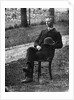 1890s 1900s Side View Of Man Wearing Suit Seated On Chair Outside Holding Bowler Hat by Anonymous
