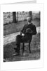 1890s 1900s Side View Of Man Wearing Suit Seated On Chair Outside Holding Bowler Hat by Anonymous