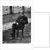 1890s 1900s Side View Of Man Wearing Suit Seated On Chair Outside Holding Bowler Hat by Anonymous