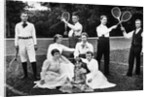 1890s 1900 Men Holding Racquets and Women and One Child In Front Of Net On Grass Tennis Court by Anonymous
