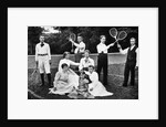 1890s 1900 Men Holding Racquets and Women and One Child In Front Of Net On Grass Tennis Court by Anonymous