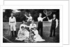 1890s 1900 Men Holding Racquets and Women and One Child In Front Of Net On Grass Tennis Court by Anonymous
