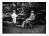 1900 Two Men Sitting Outside In Chairs Among Trees Smoking Cigars Talking Dog Laying At Their Feet by Anonymous
