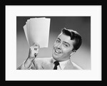 1950s Young Businessman Holding Up Handful Of Papers by Anonymous