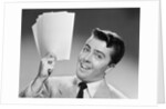 1950s Young Businessman Holding Up Handful Of Papers by Anonymous