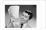 1950s Young Businessman Holding Up Handful Of Papers by Anonymous