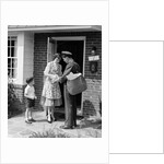 1950s Suburban Mom At Home Front Door With Son Watching Receiving Package From Mailman by Anonymous