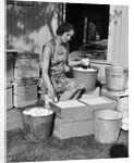 1930s Woman Farm Wife Sitting Outside Of Hen House Doorway Putting Eggs From Pails Into Shipping Crates by Anonymous