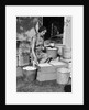 1930s Woman Farm Wife Sitting Outside Of Hen House Doorway Putting Eggs From Pails Into Shipping Crates by Anonymous
