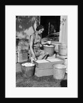 1930s Woman Farm Wife Sitting Outside Of Hen House Doorway Putting Eggs From Pails Into Shipping Crates by Anonymous