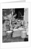 1930s Woman Farm Wife Sitting Outside Of Hen House Doorway Putting Eggs From Pails Into Shipping Crates by Anonymous