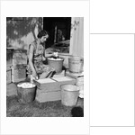 1930s Woman Farm Wife Sitting Outside Of Hen House Doorway Putting Eggs From Pails Into Shipping Crates by Anonymous