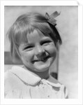 1930s Young Girl Outdoor Portrait With Freckles And Bow In Hair At Camera by Anonymous