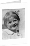 1930s Young Girl Outdoor Portrait With Freckles And Bow In Hair At Camera by Anonymous