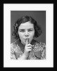 1930s Portrait Of Young Girl With Finger To Mouth Making Shush Be Quiet Expression by Anonymous