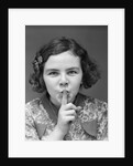 1930s Portrait Of Young Girl With Finger To Mouth Making Shush Be Quiet Expression by Anonymous